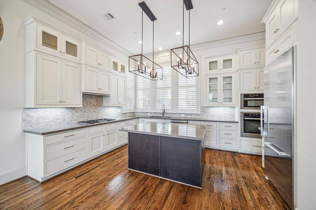 Well-appointed kitchen with high end Miele appliances and island with storage.