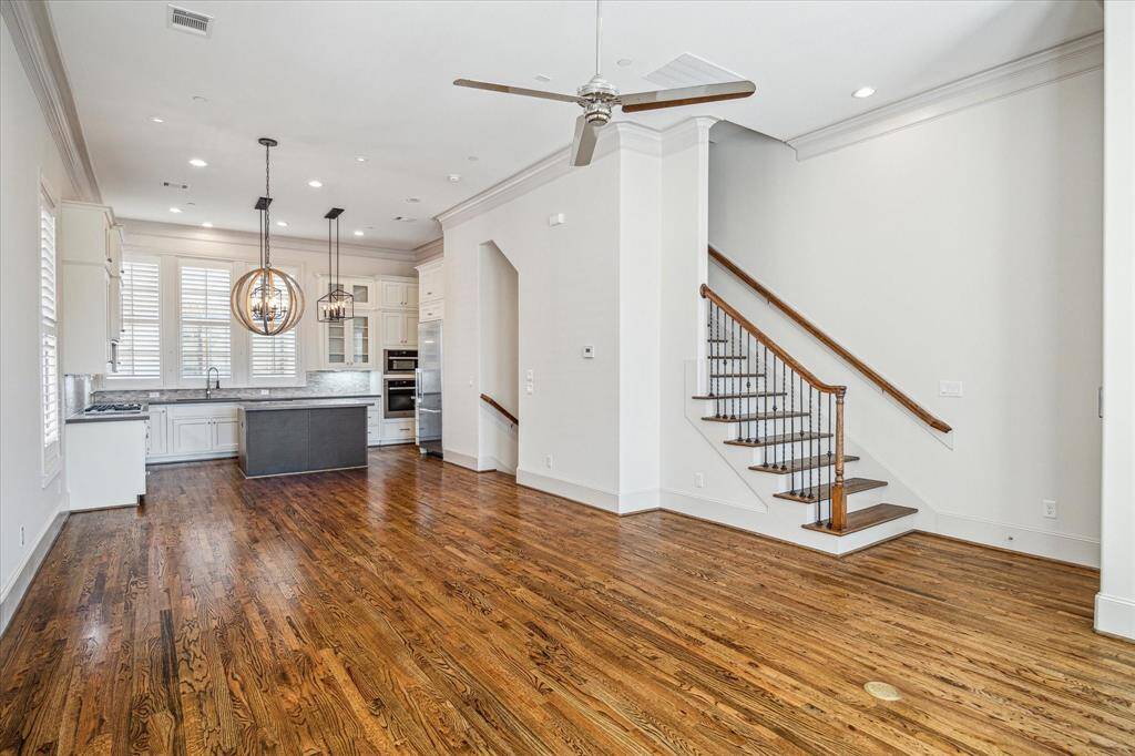 Living room to the kitchen showing the staircase.