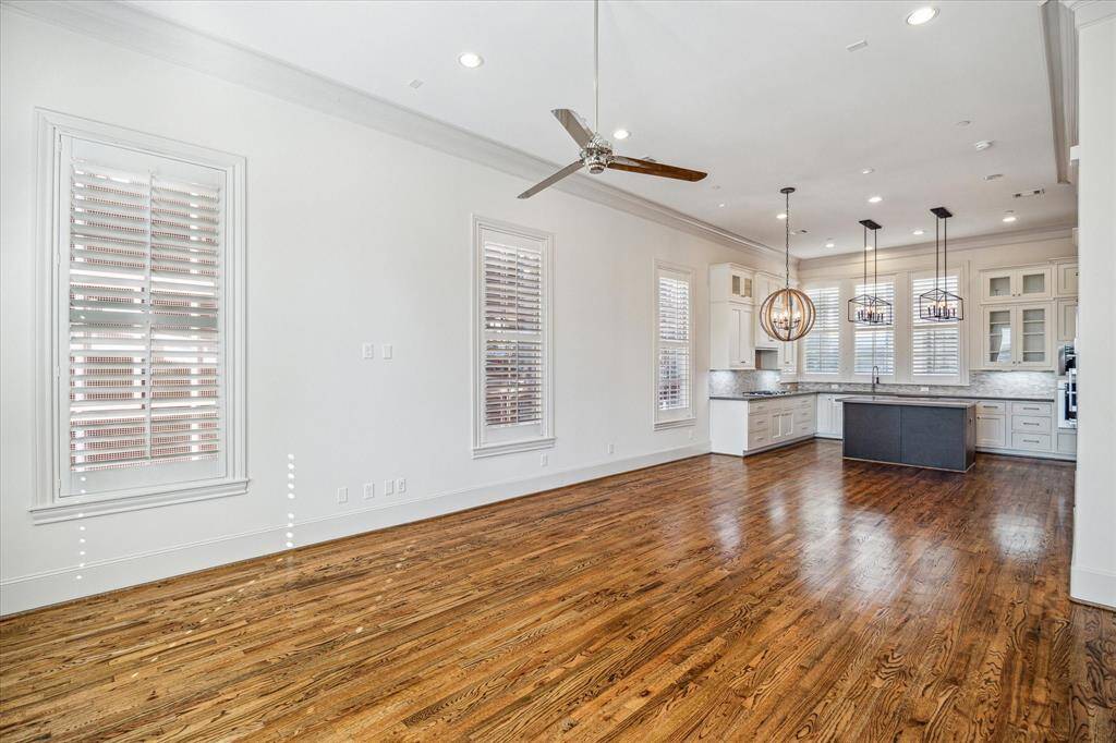 Note the wood floors, high ceilings, crown molding, shutters, great lighting...