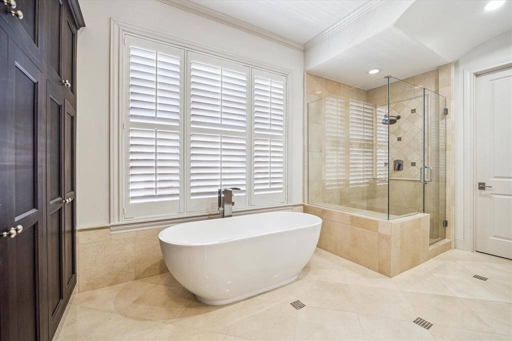 Walk-in shower, soaking tub with frameless glass enclosure.