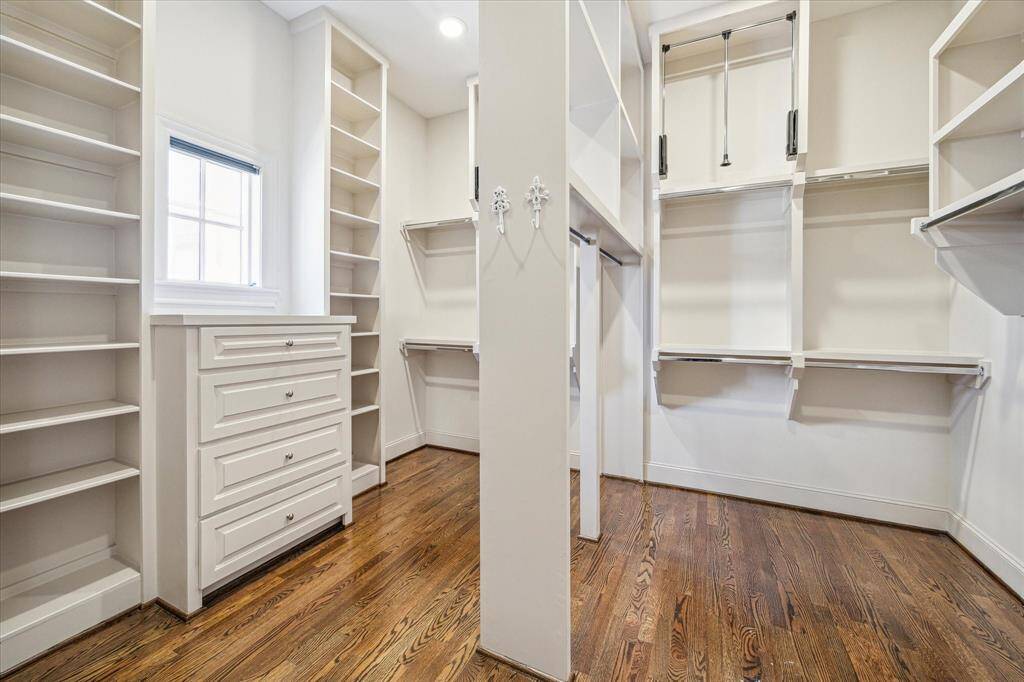 Huge primary closet with closet system, built-in dresser, shelving...