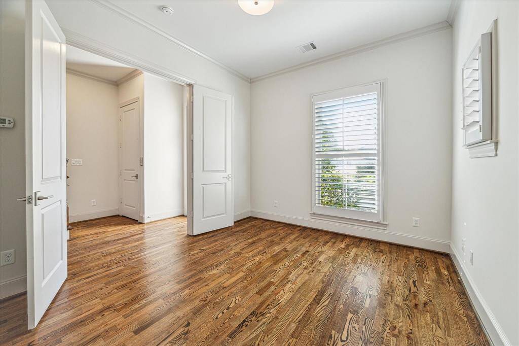 1st floor ensuite bedroom with shutters, wood floors.