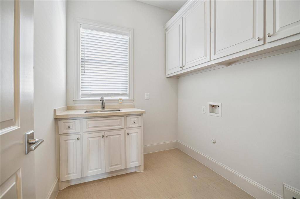 3rd floor laundry room with sink and lots of storage.