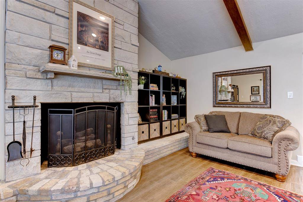 The striking floor to ceiling fireplace is beautifully custom designed. This creates a natural focal pint, framed by vaulted ceilings.