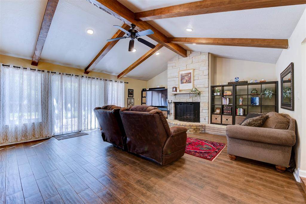 Soft natural light from the floor to ceiling windows featuring  a high-end Pella sliding glass door leading to the Saltillo tile patio for outdoor entertaining.