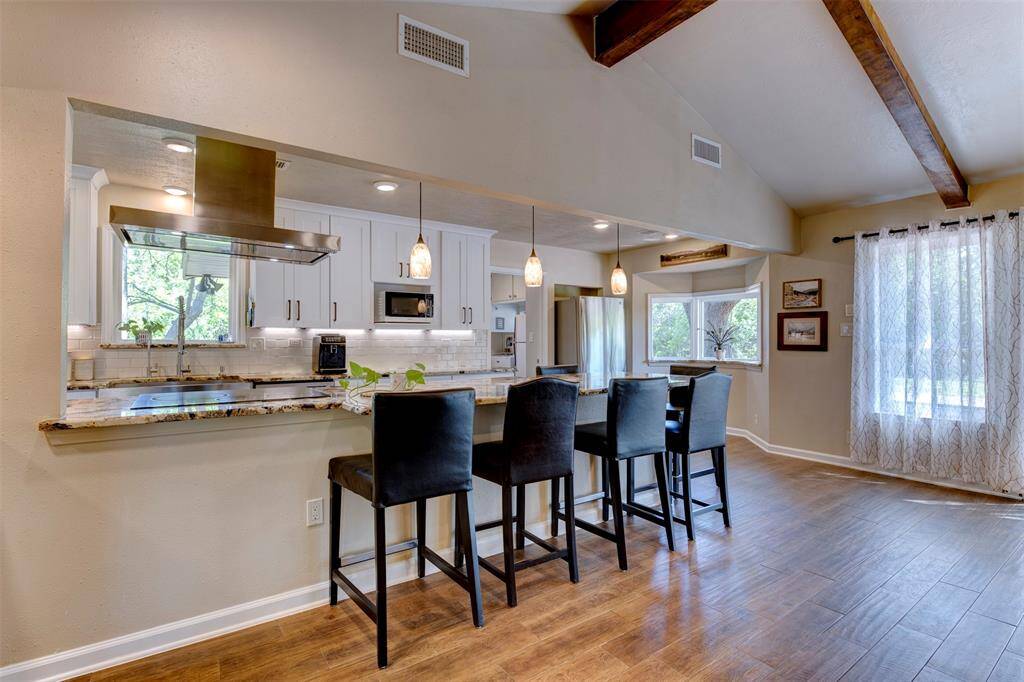 A view of the kitchen bar area coming in from the  foyer. More chairs could easily fit if needed.