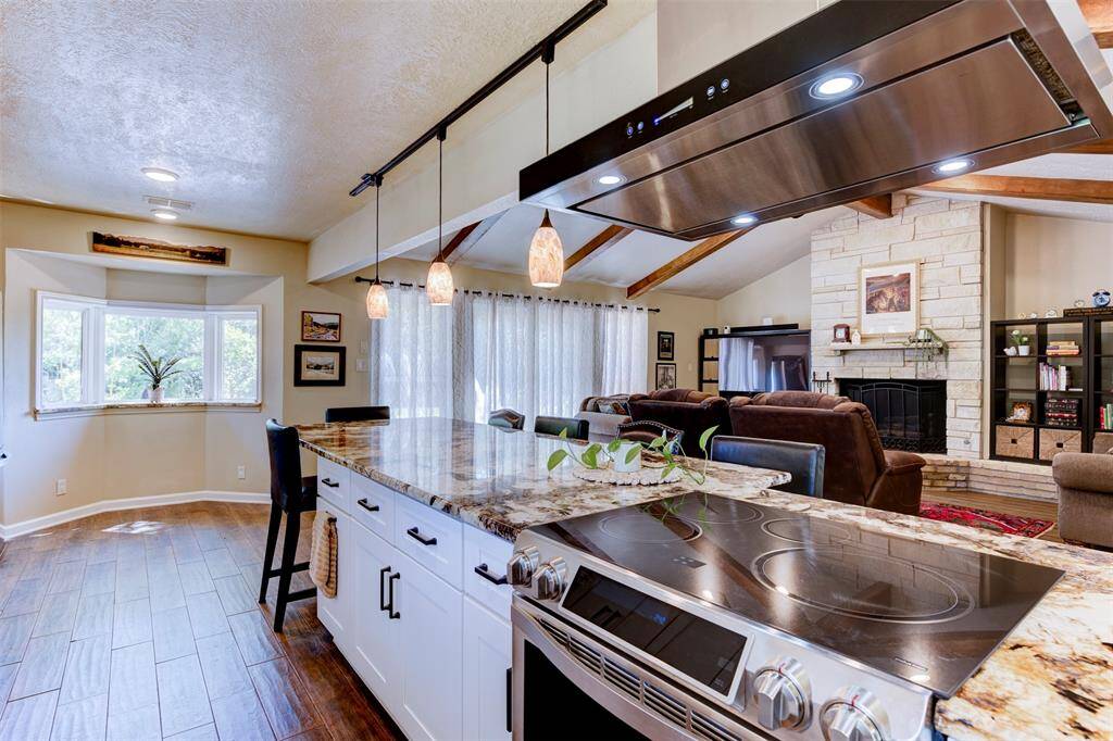 Cook like a pro with this Samsung chef series flat top induction cooktop with convection oven for fast precise cooking. The open sight line into the living area and the way the bay window draws light across the kitchen makes the space feel connected and expansive.
