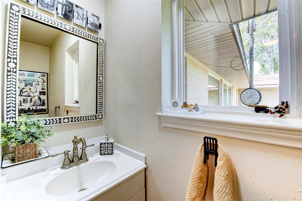 This is a handy half bath close to the backyard door access. (The mirror is excluded from sale.)
