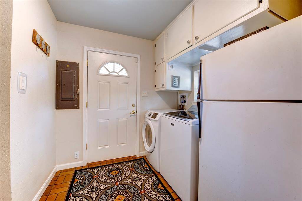 The laundry/mud room is both practical and polished with with space for extra refrigerator,additional cabinets, attractive flooring and backyard access.