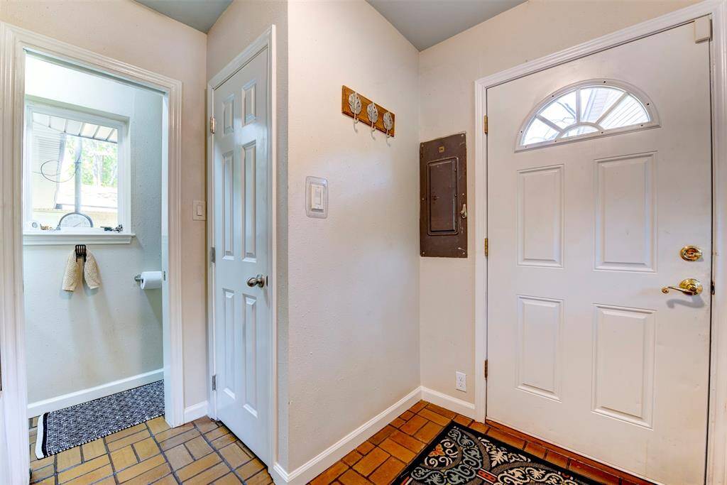 A half bath is conveniently located between the back door and kitchen with a dedicated closet for cleaning supplies or extra pantry space.