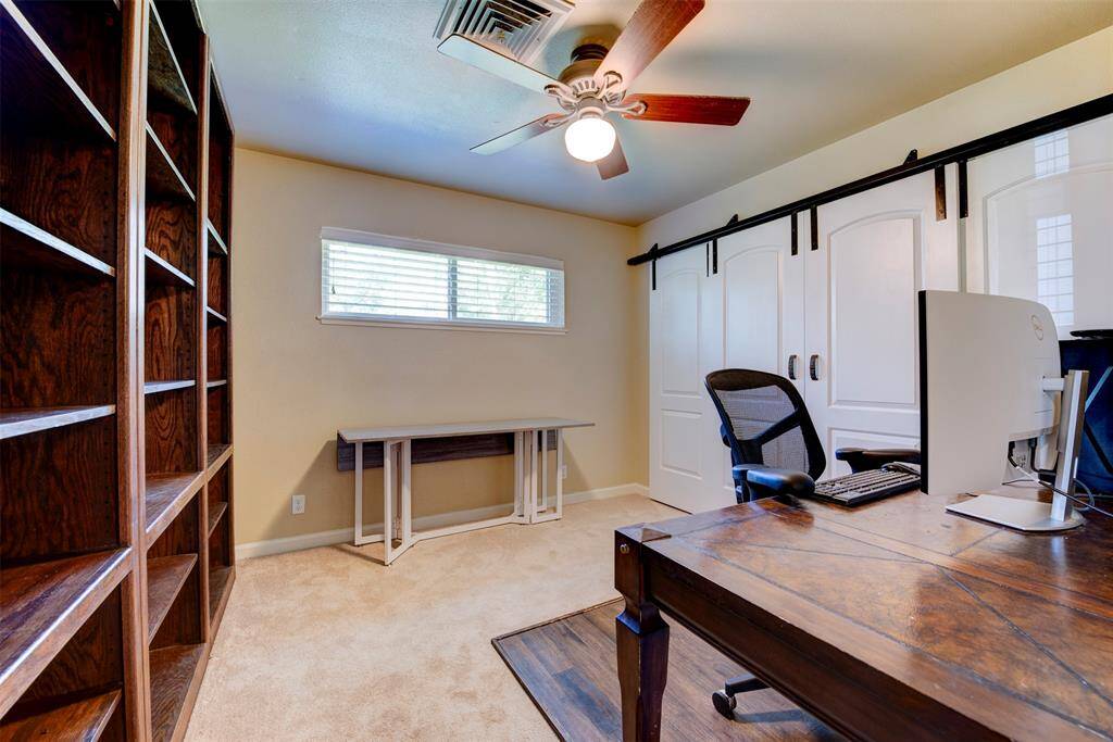 This bedroom features a sliding barn-style closet doors which add a stylish and functual touch. (Book shelves are excluded)