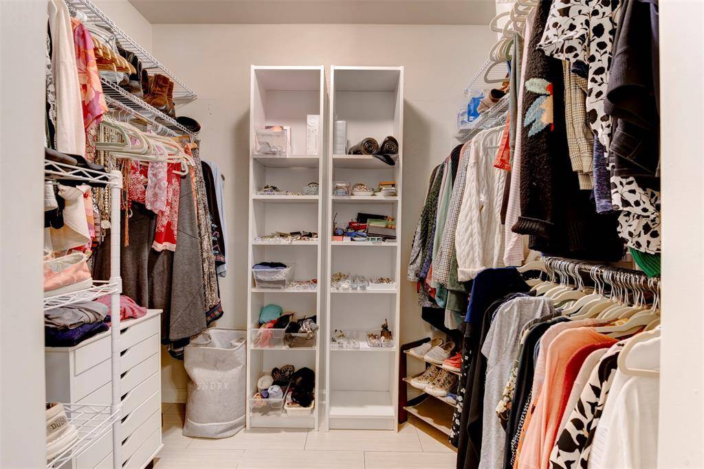 This over sized walk in closet offers ample hanging space. Extra space to customize for your personal needs.(Drawers and shelving not attached-excluded)