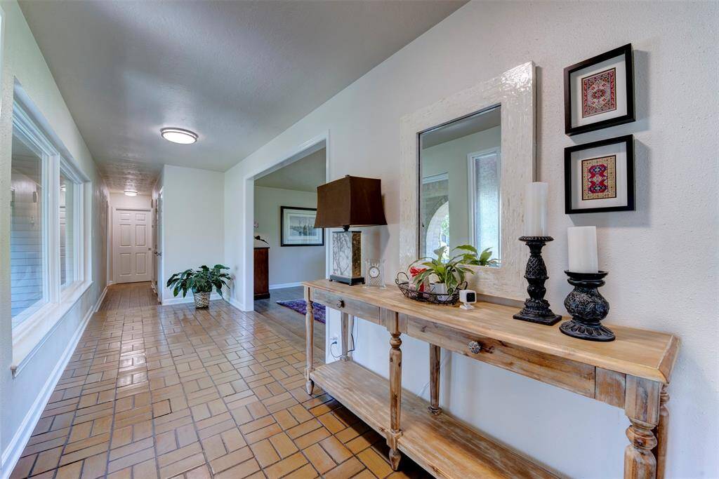 Charming entrance hall accented by soft lighting. Generous windows overlook the front patio arches bringing the natural light and garden views.