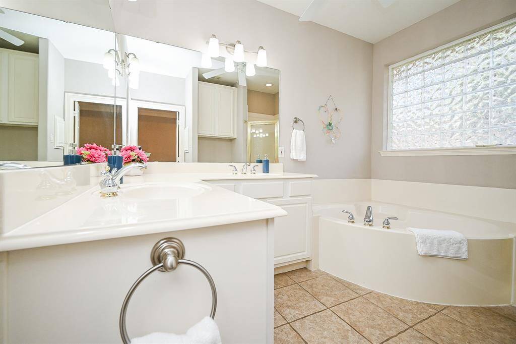 Don't you love the luxurious separate bathtub, under a wall of private art-deco like windows?