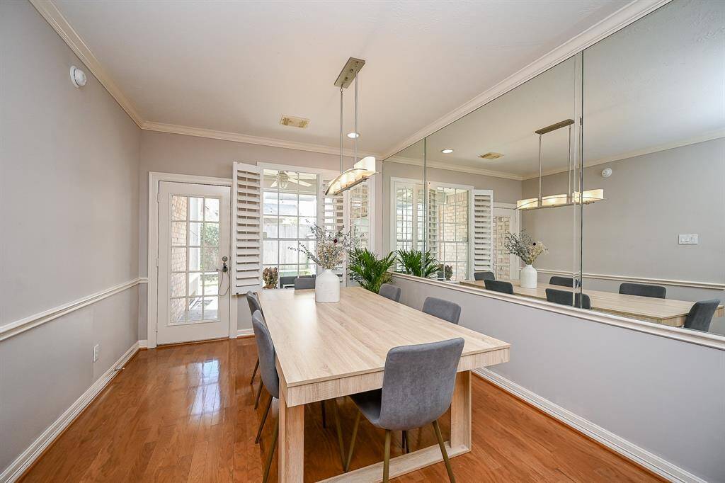 Every wall and surface shines in this gorgeous formal dining room, right off the kitchen, with handy patio door, up left.