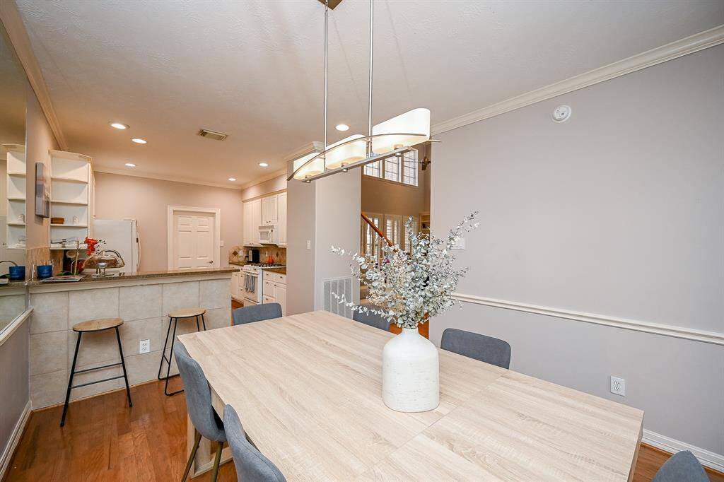 The open floor plan design concept offers wide open beauty and versatility in every home space; including this view from /dining nook, into kitchen, and beyond (right) into the living area.