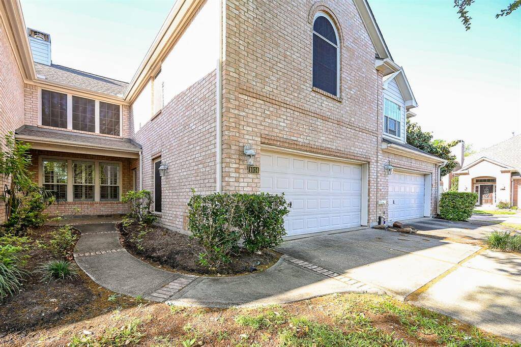 Impeccably maintained, inside and out, this treasure offers extraordinary curb appeal, in this view of private attached garages, brick accented walkways, and covered main entry.