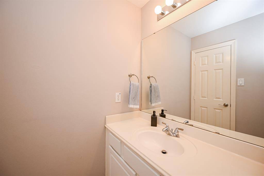 Peaceful pale earth tones on walls, sink counter and cabinetry below, ensure relaxation and refreshing in this secondary bathroom.
