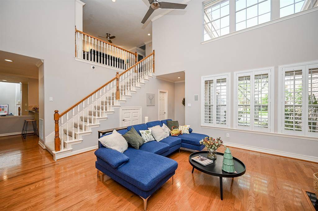 Pure natural light embraces this incredibly satisfying view of the living room with a beautiful glimpse of the gorgeous staircase.