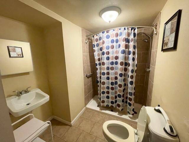 This bathroom offers essential fixtures and smart use of space, complementing the layout with convenience and functionality.