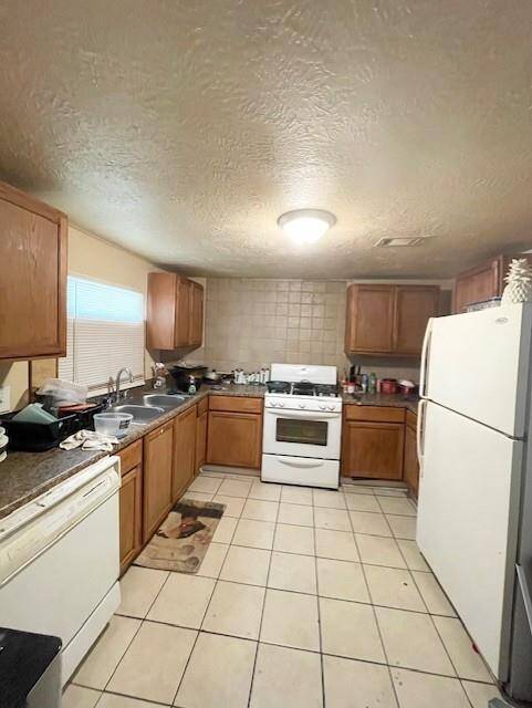 A large culinary zone offering generous cabinetry and broad counter surfaces. This kitchen provides a solid foundation for creative reinvention.