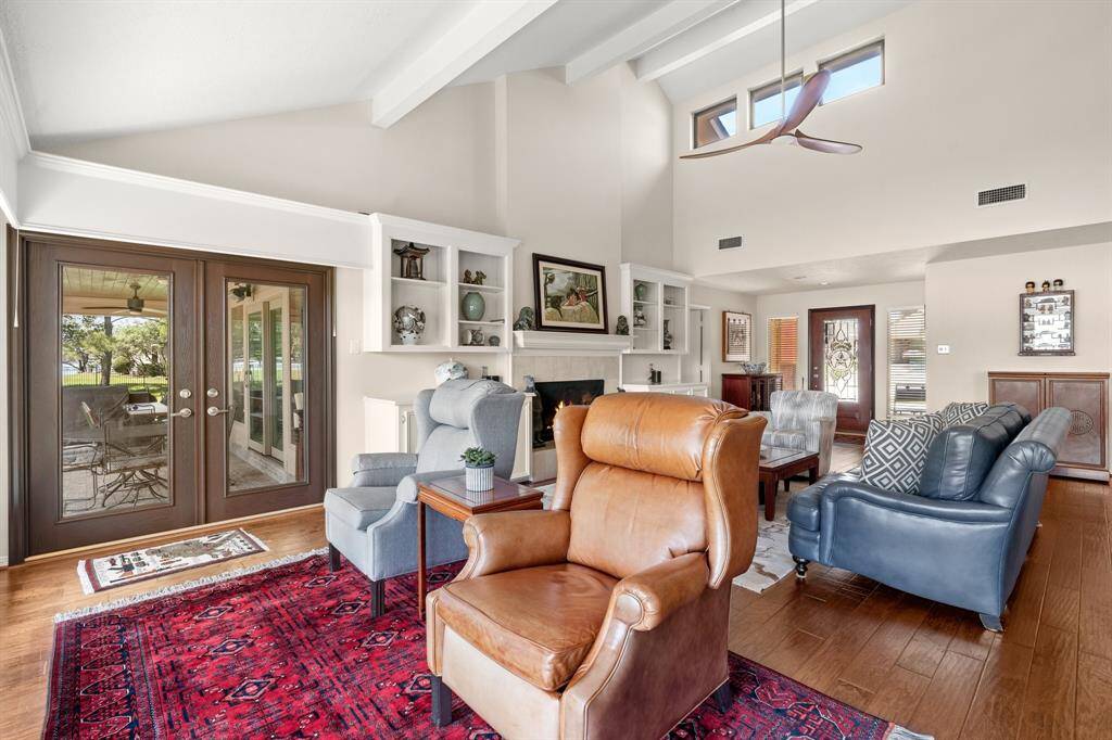 Spacious living room with access to both covered outdoor areas.
