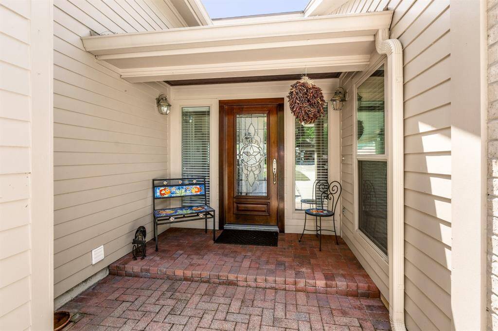 Covered porch with brick entry.