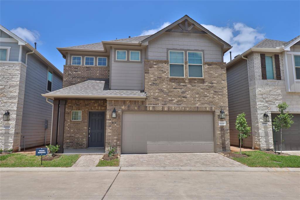 This is a modern two-story home. It features a two-car garage and multiple windows for natural light.