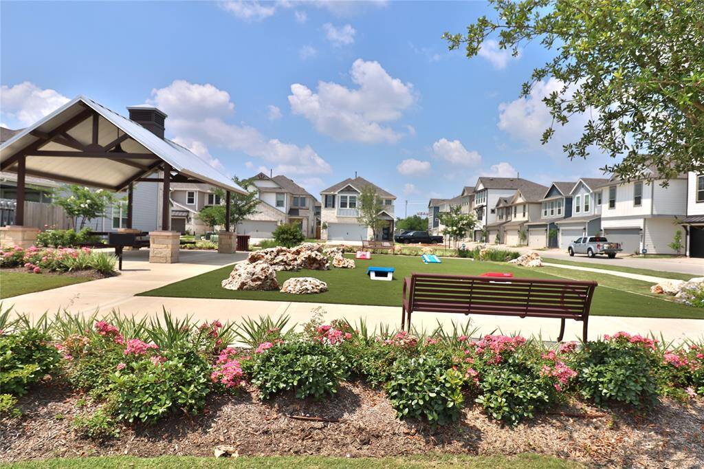 Charming community park with lush greenery and inviting space for relaxation and play.
