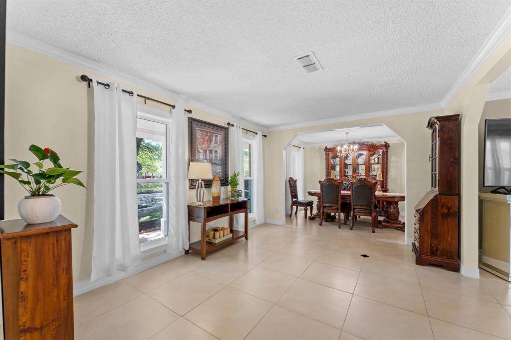 This huge front room, off the main hallway. offers so many options, including a spacious formal dining area and/or pleasant sitting room.