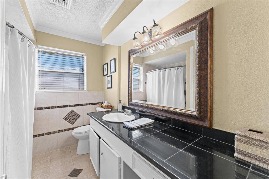 The restroom features a tub and sink, with convenient access for both bedroom #2 and #3.