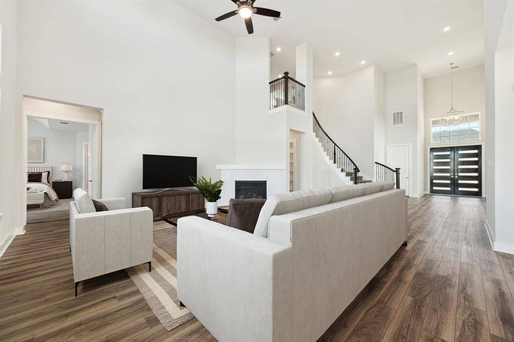 Sophisticated and luxurious entrance with grand staircase. Virtually staged.