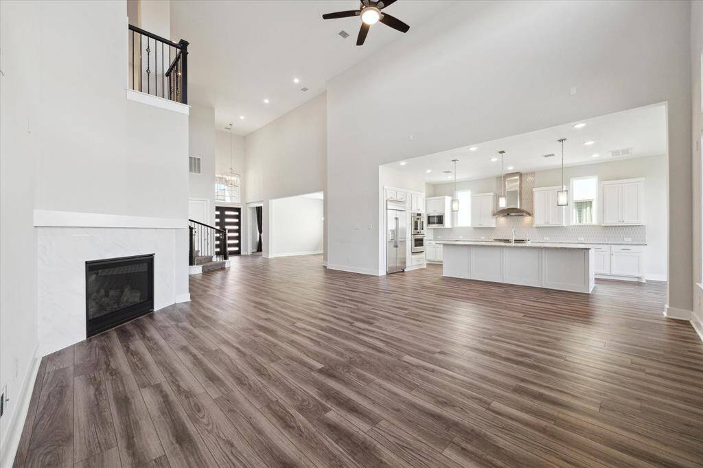 A view of the living room with cathedral ceilings  - kitchen opens up to.
