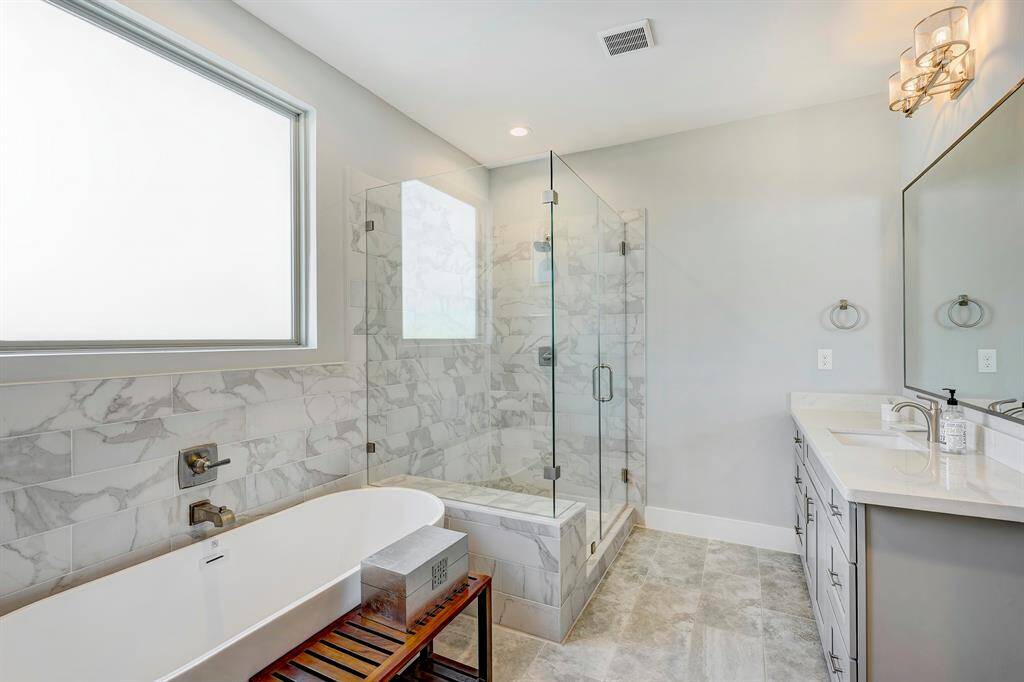 Primary bath close up of soaking tub and walk-in shower.