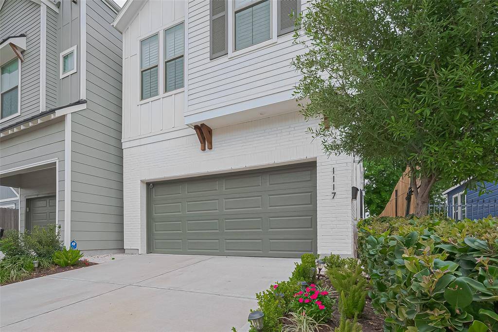 2 car garage with epoxy floor and extra space for refrigerator and storage.