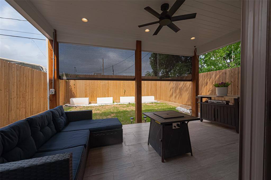 Covered patio viewing towards the yard. Stained fence and solar lighting.