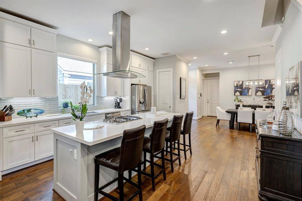 Spacious island kitchen with breakfast bar, stainless steel appliances, gas stove, beverage refrigerator, walk-in pantry and abundant storage. Large closet under the staircase.