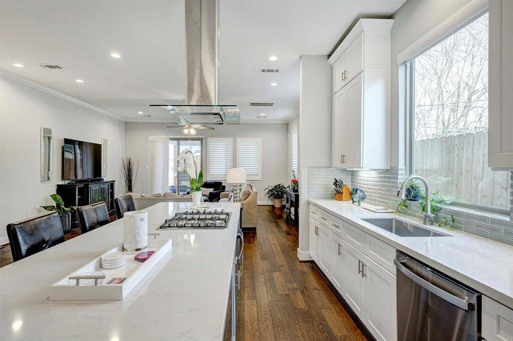 Close up of  the island with plenty of counter space, undermount stainless steel sink and under cabinet lighting.