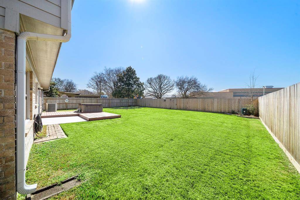 This photo showcases a spacious backyard with a well-maintained lawn!