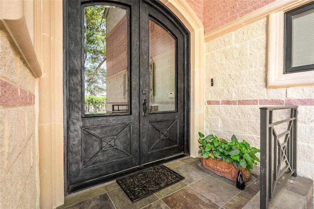 Custom double iron doors and slate entrance.