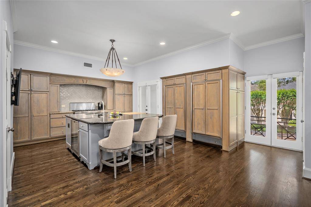 Gorgeous island kitchen with a Sub-Zero refrigerator, gas range, and mini-wine cooler. The kitchen includes two balconies overlooking the entrance. Elevator access in kitchen.