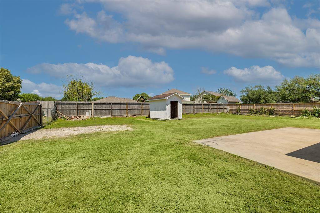 Large backyard with additional shed for storage.