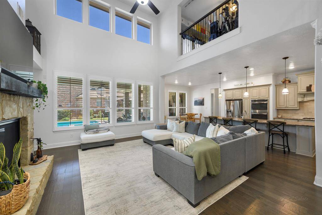 Fall in love with this gorgeous two-story living room with a wall of windows, allowing for lots of natural light.