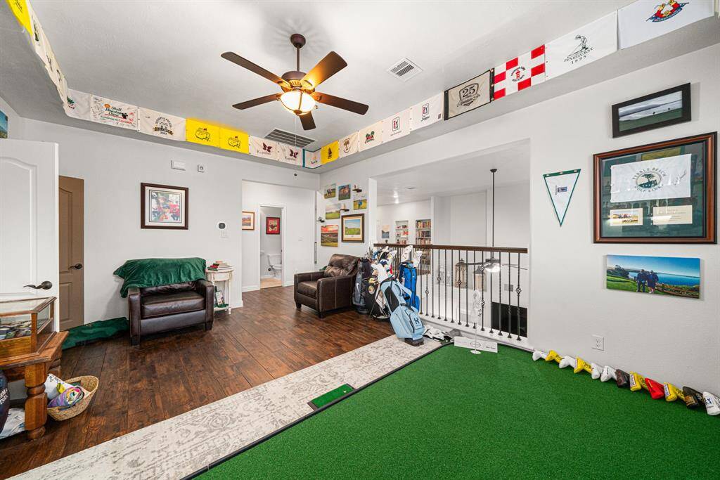 Game room upstairs, currently being used as a golf putting green and memorabilia space.