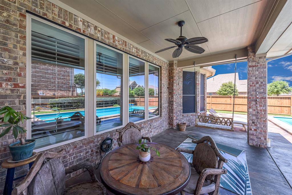 Multiple seating areas, including a dining area, porch swing, and loungers around the pool!