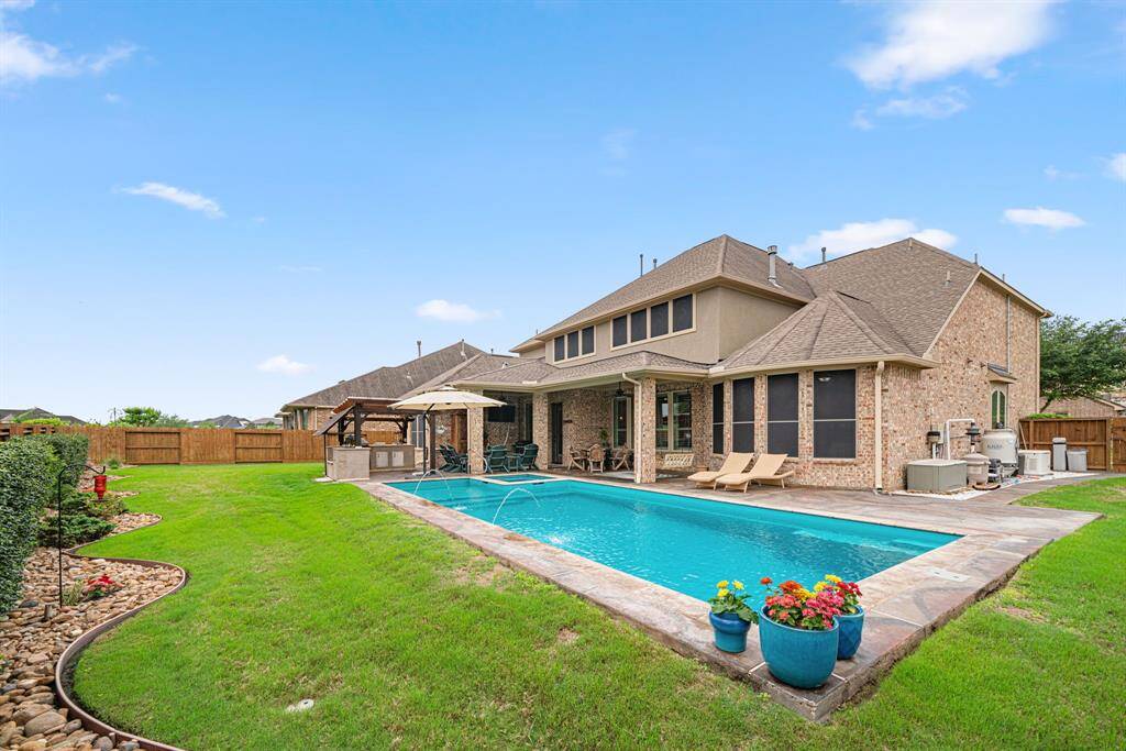 Plenty of green space surrounding the pool and outdoor kitchen for gardening and play!