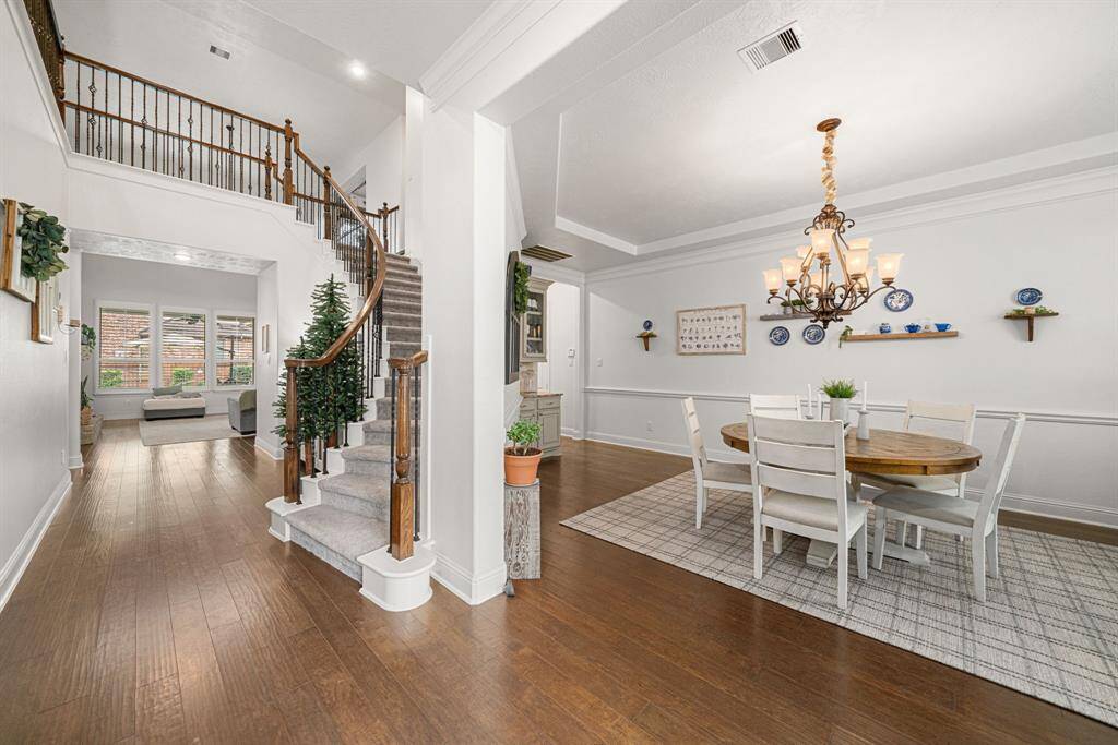 Be immediately greeted with hardwood floors, crown molding, a beautifully curved stairway with catwalk, and high ceilings!