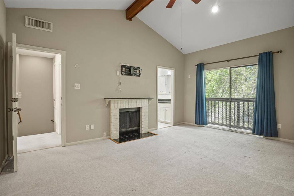 Step into the spacious primary bedroom with a cozy fireplace, high ceilings, walk-in closet and a Juliet balcony.
