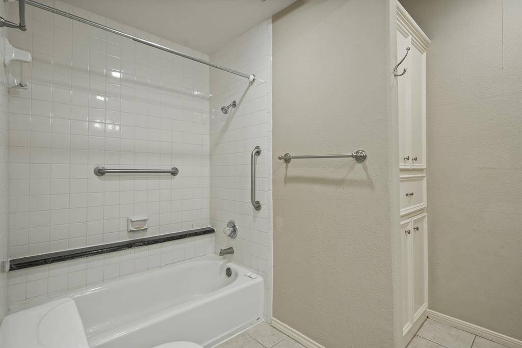 The primary bathroom has a tub and shower combo with tile surround.