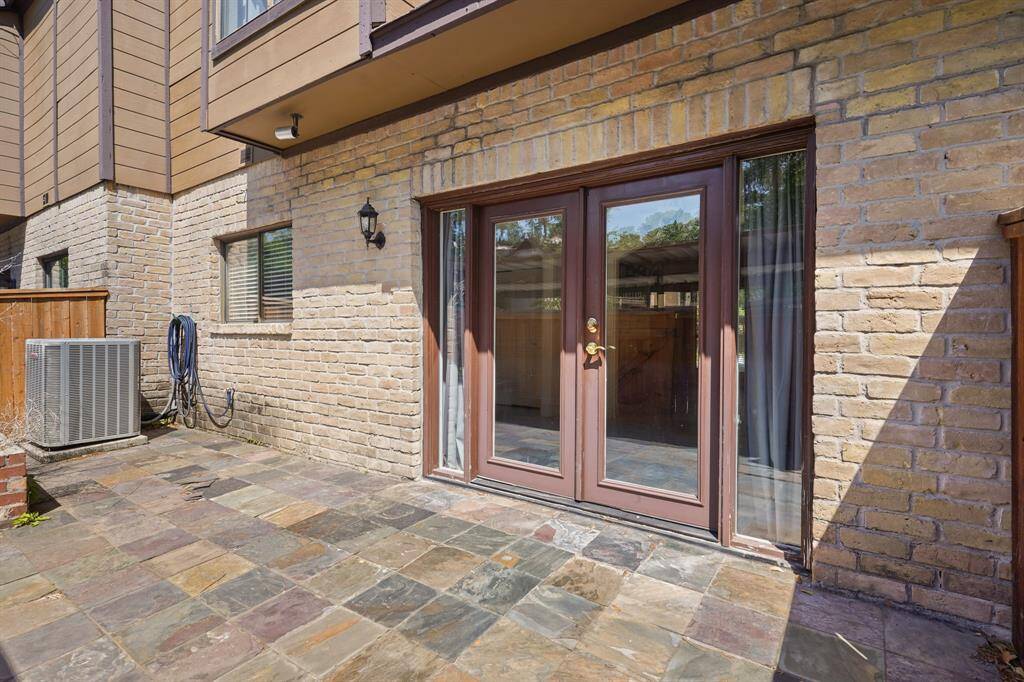 The spacious paved back patio with french doors that lead to the dining room. From the patio there is gate access that leads right to your parking spot for added convenience.